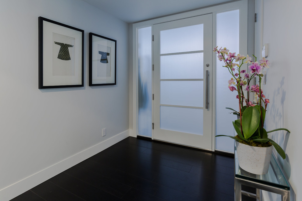 Mid-sized transitional dark wood floor entry hall photo in Los Angeles with gray walls and a glass front door