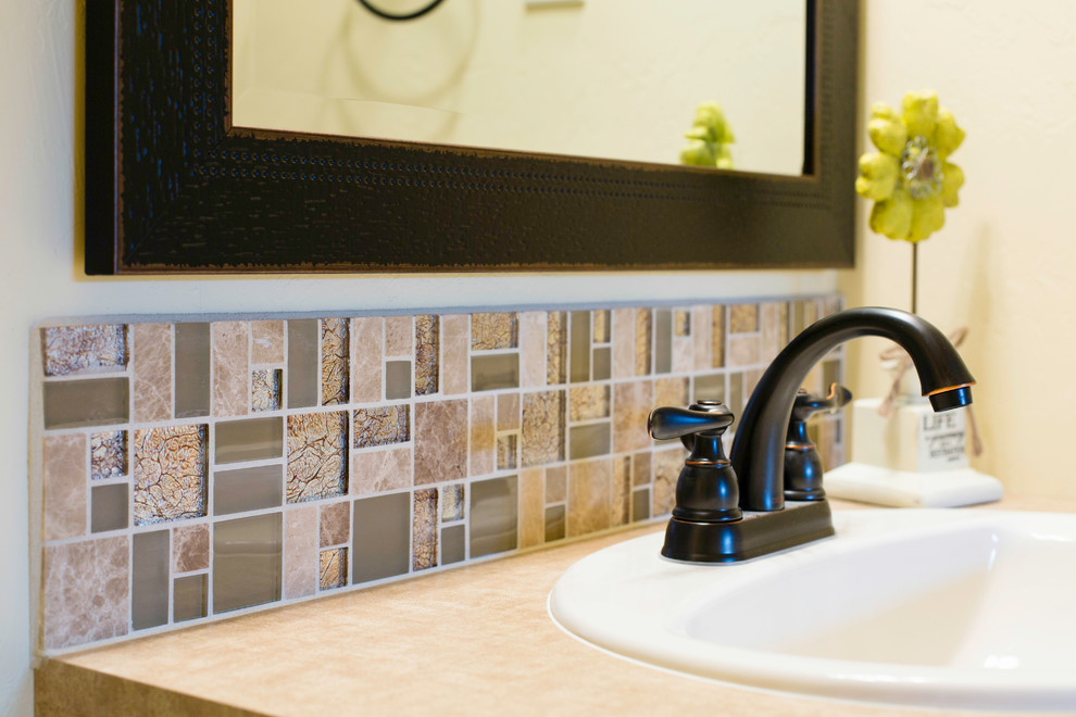 Example of a small transitional 3/4 multicolored tile and glass tile bathroom design with beige walls and a drop-in sink