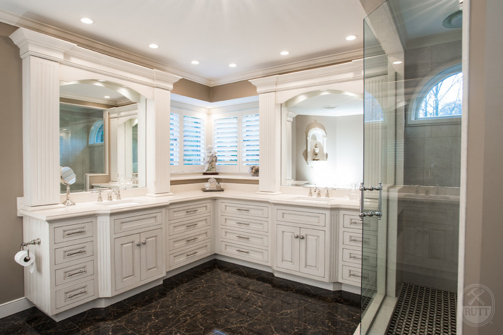 This is an example of a large classic ensuite bathroom in Other with beaded cabinets, white cabinets, a corner shower, beige tiles, beige walls, marble flooring, a submerged sink, black floors, a hinged door, beige worktops, double sinks and a built in vanity unit.