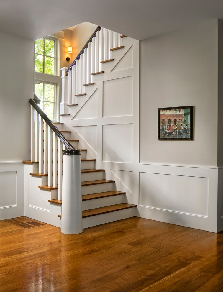 Design ideas for a mid-sized traditional wood u-shaped staircase in Dallas with wood risers and metal railing.