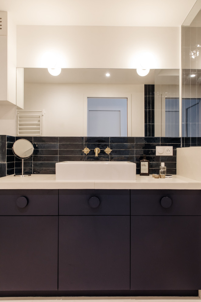 Small modern master bathroom in Paris with blue tile, solid surface benchtops and a built-in vanity.