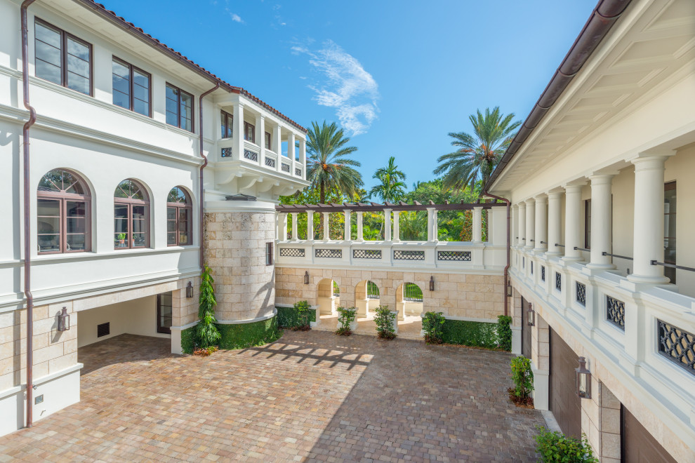 This is an example of a large mediterranean attached four-car porte cochere in Other.