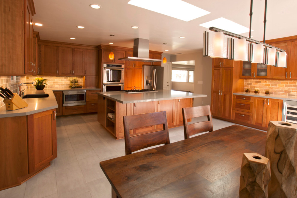 Inspiration for a large transitional u-shaped eat-in kitchen remodel in San Francisco with shaker cabinets, medium tone wood cabinets, quartz countertops, ceramic backsplash, stainless steel appliances and an island