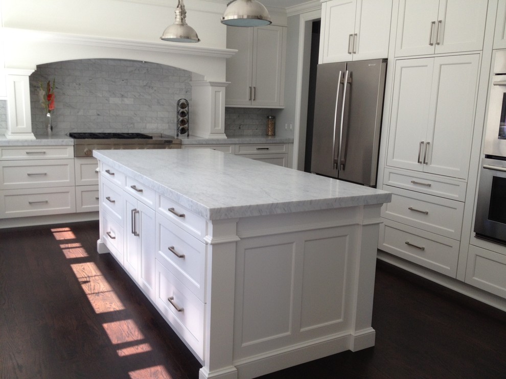 Inspiration for a mid-sized transitional u-shaped medium tone wood floor eat-in kitchen remodel in Detroit with a single-bowl sink, recessed-panel cabinets, white cabinets, marble countertops, gray backsplash, subway tile backsplash, stainless steel appliances and an island