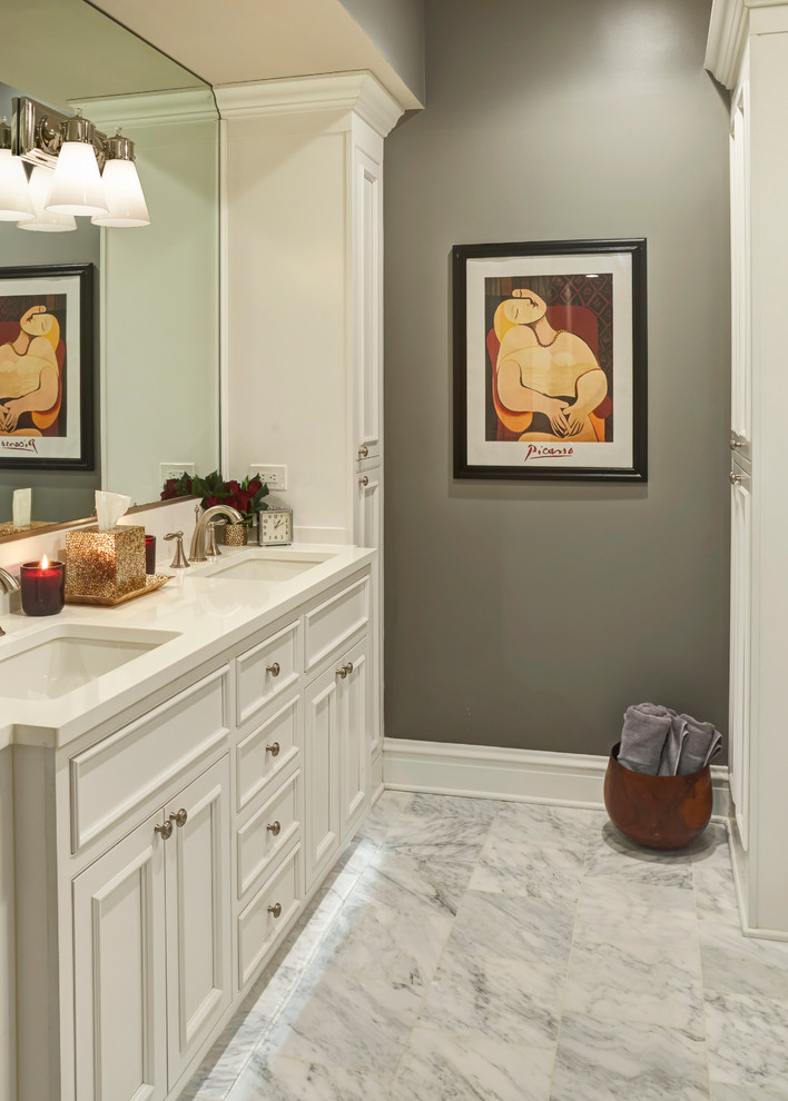 Design ideas for a mid-sized transitional master bathroom in Chicago with recessed-panel cabinets, white cabinets, white tile, stone tile, grey walls, marble floors and an undermount sink.
