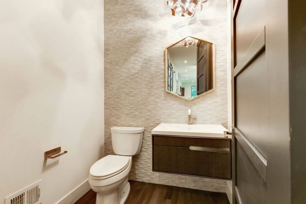 Inspiration for a mid-sized contemporary powder room in DC Metro with flat-panel cabinets, brown cabinets, a two-piece toilet, gray tile, ceramic tile, white walls, dark hardwood floors, a wall-mount sink, marble benchtops, brown floor and white benchtops.
