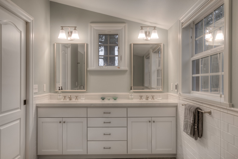 Design ideas for a large traditional master bathroom in Seattle with recessed-panel cabinets, white cabinets, an alcove shower, a one-piece toilet, white tile, subway tile, grey walls, marble floors, an undermount sink and granite benchtops.