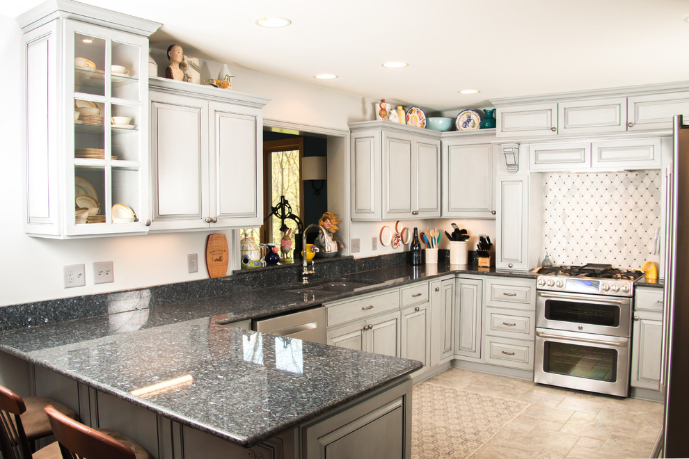 Large transitional u-shaped porcelain tile and beige floor eat-in kitchen photo in Milwaukee with an undermount sink, raised-panel cabinets, gray cabinets, granite countertops, white backsplash, marble backsplash, stainless steel appliances and no island