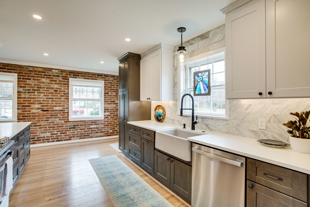 Kitchen - small transitional single-wall kitchen idea in DC Metro with a farmhouse sink, quartz countertops, stainless steel appliances and a peninsula