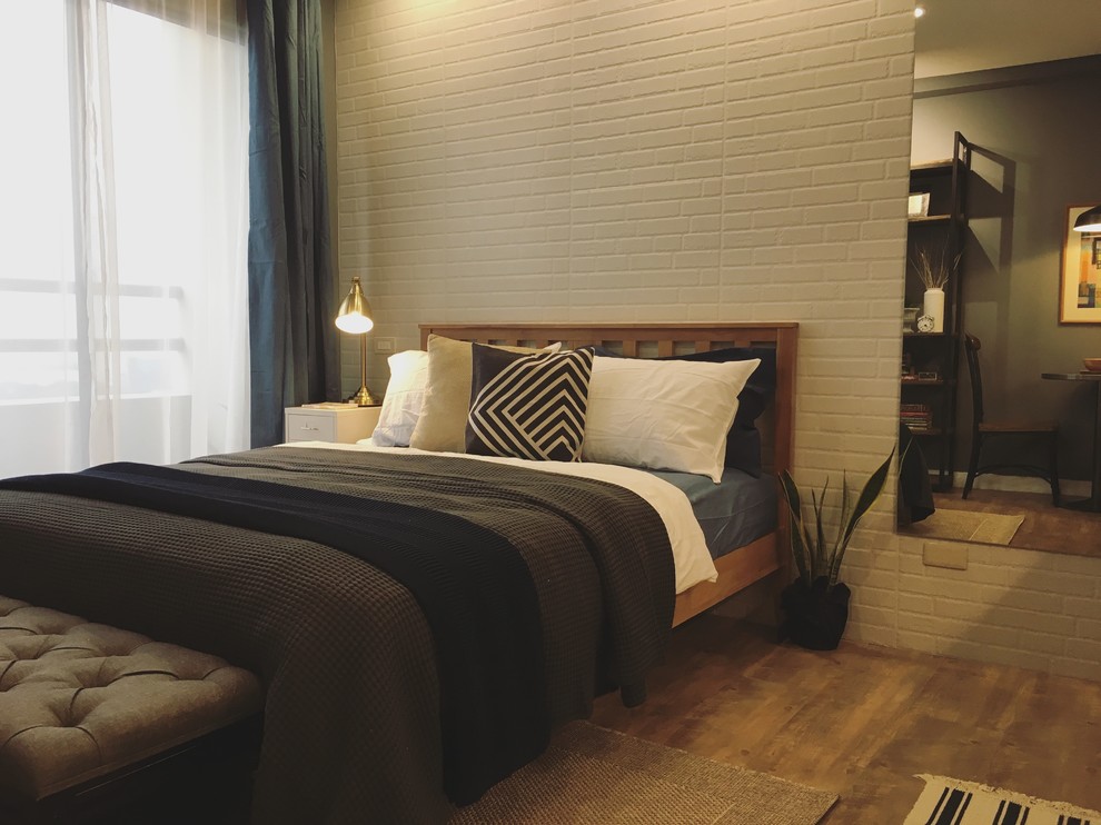 Example of a small urban master light wood floor bedroom design with gray walls