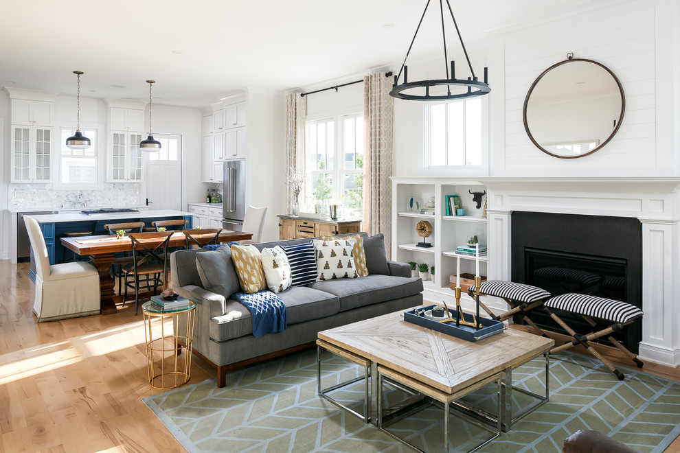 Design ideas for a mid-sized transitional open concept family room in Louisville with white walls, light hardwood floors, a standard fireplace, a stone fireplace surround and no tv.