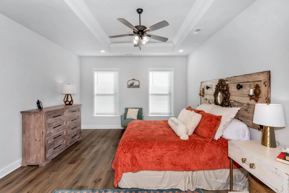 Medium sized traditional master bedroom in New Orleans with grey walls, vinyl flooring and brown floors.