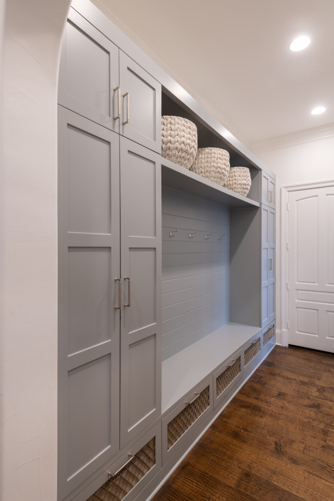 Photo of a large traditional mudroom in Dallas with white walls and medium hardwood floors.
