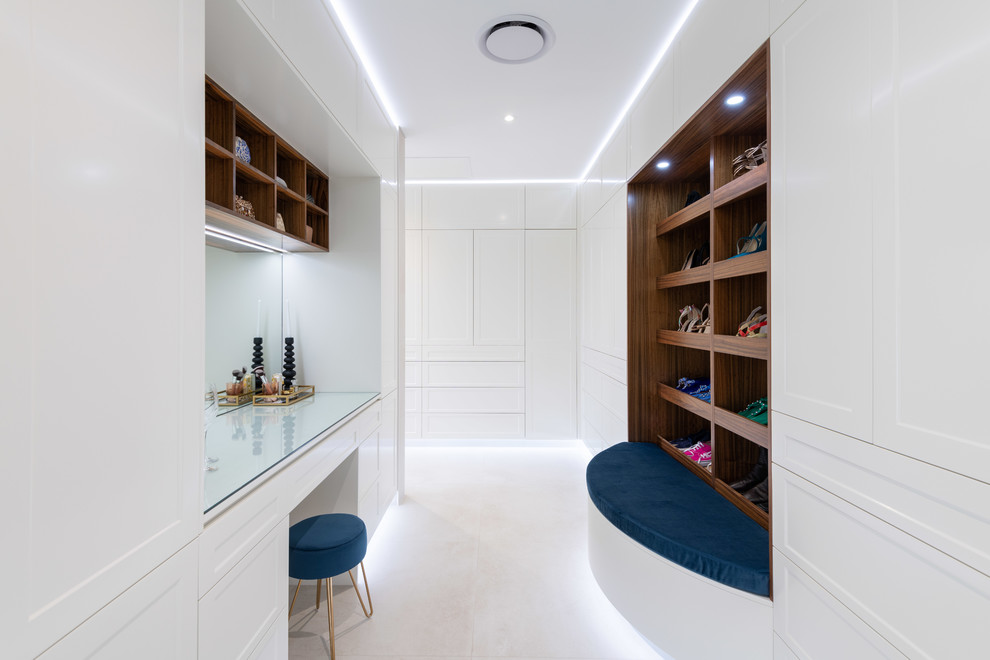 Design ideas for a large contemporary gender-neutral walk-in wardrobe in Cairns with shaker cabinets, yellow cabinets, porcelain floors and beige floor.