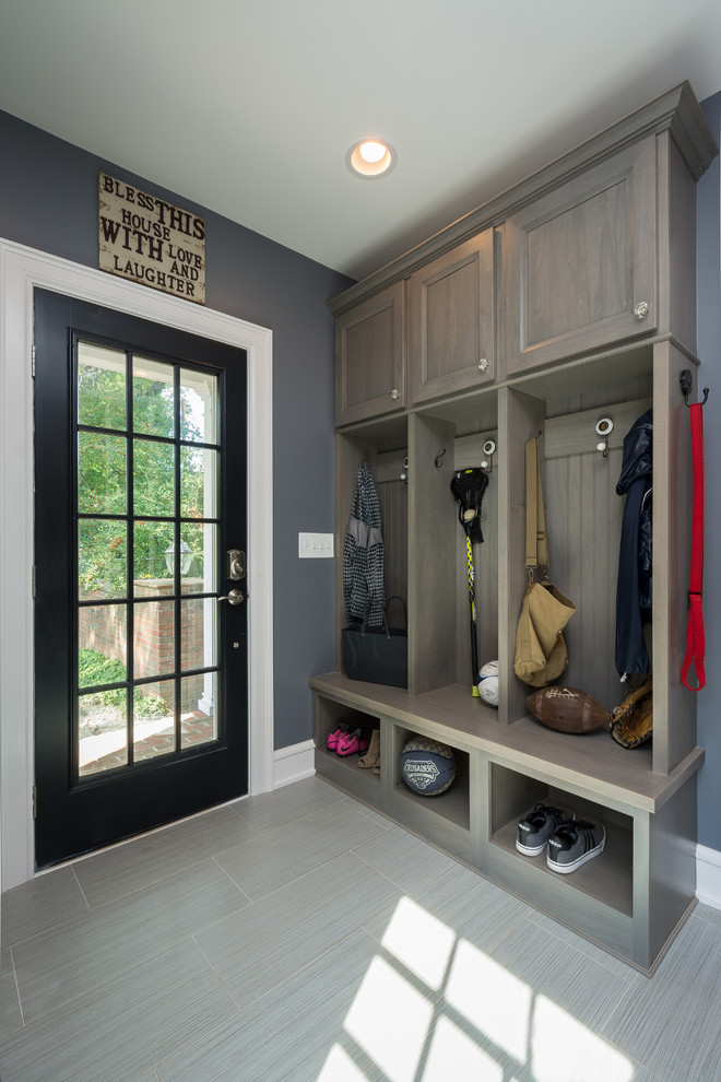 Design ideas for a mid-sized transitional utility room in Columbus with an undermount sink, flat-panel cabinets, grey cabinets, quartz benchtops, blue walls, porcelain floors, a side-by-side washer and dryer and grey floor.