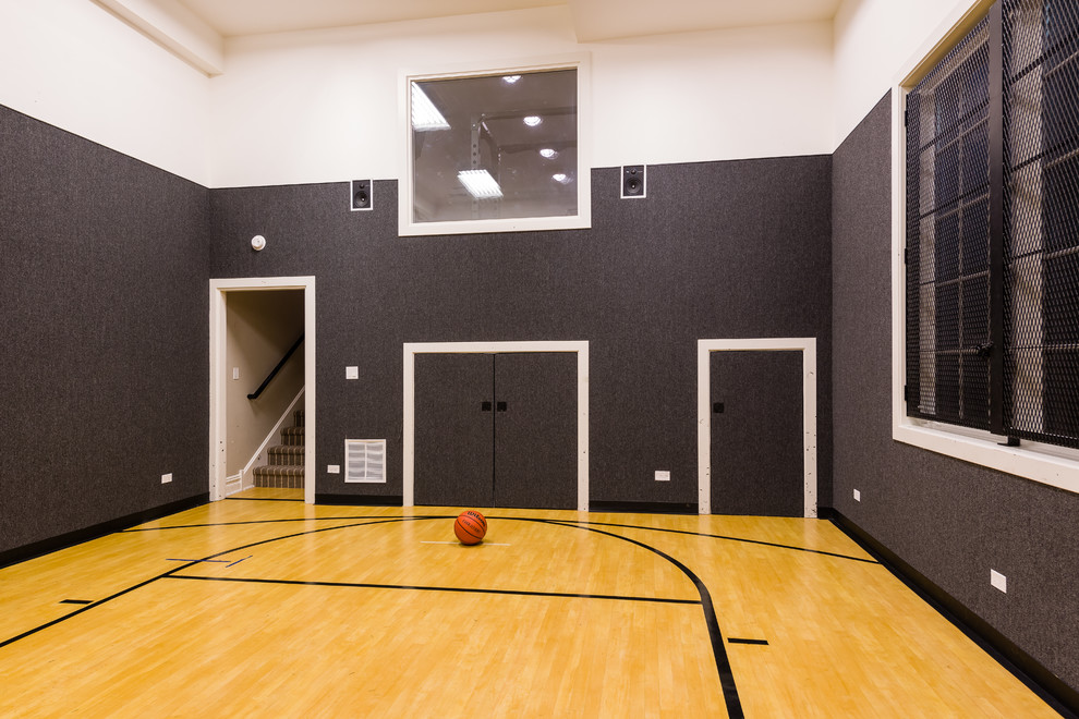 This is an example of a mid-sized traditional indoor sport court in Chicago with grey walls, light hardwood floors and brown floor.