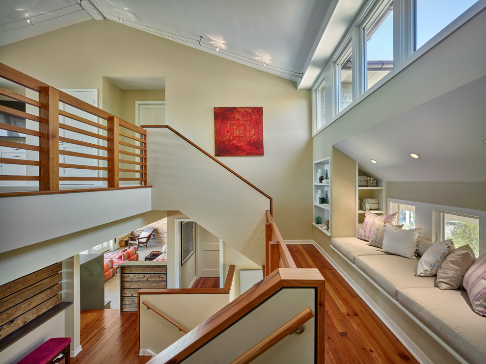 Beach style medium tone wood floor hallway photo in New York with beige walls