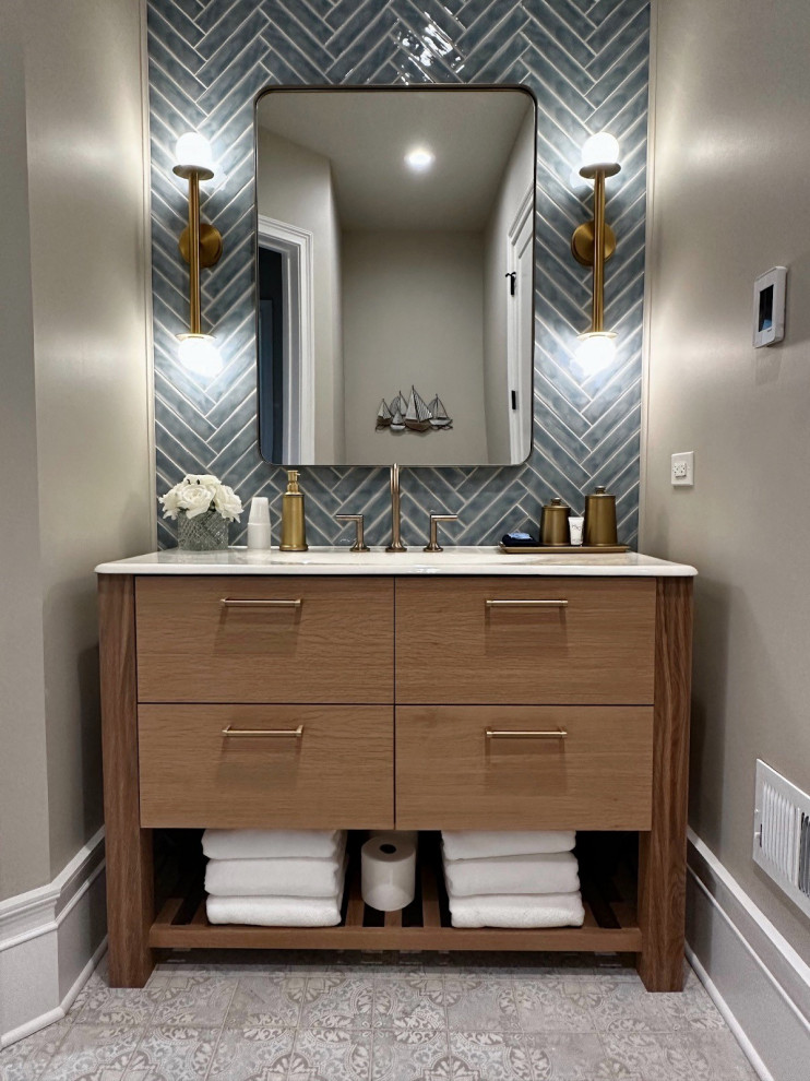 Inspiration for a mid-sized bathroom in Chicago with flat-panel cabinets, medium wood cabinets, blue tile, grey floor, white benchtops, a single vanity and a freestanding vanity.