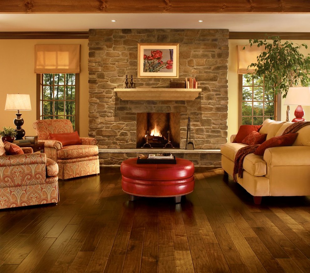 Inspiration for a mid-sized country open concept living room in Other with beige walls, dark hardwood floors, a standard fireplace and a stone fireplace surround.