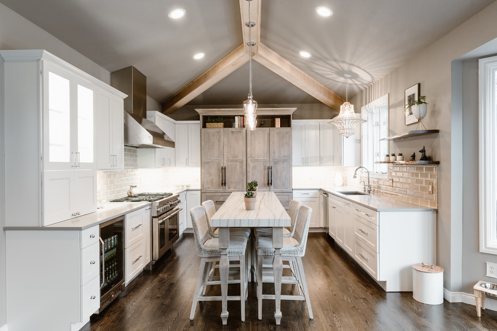 Design ideas for a country u-shaped kitchen in Detroit with an undermount sink, shaker cabinets, white cabinets, grey splashback, stainless steel appliances, dark hardwood floors, with island, brown floor and grey benchtop.