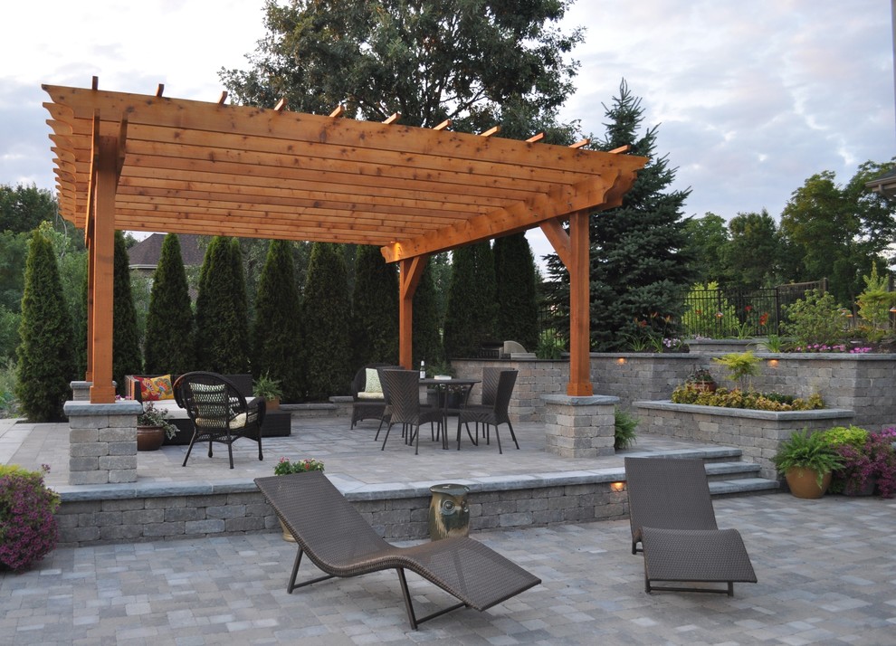 Mid-sized contemporary backyard patio in Chicago with an outdoor kitchen, brick pavers and a gazebo/cabana.