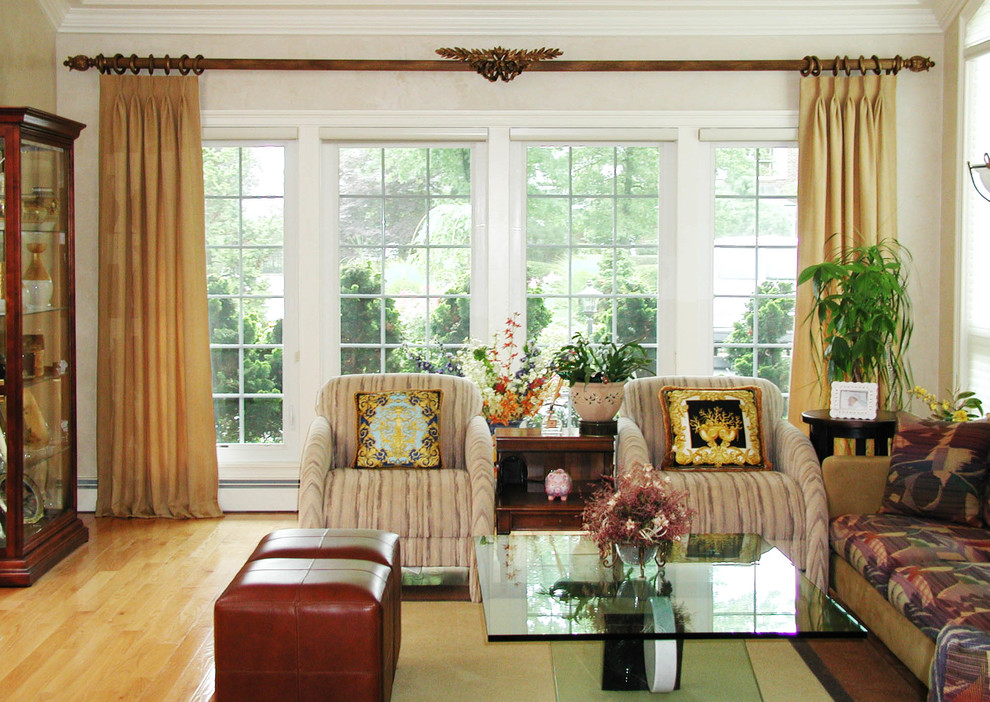 Photo of a large traditional formal enclosed living room in New York with multi-coloured walls, light hardwood floors, no fireplace and no tv.