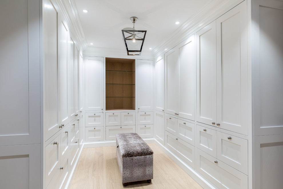 Transitional storage and wardrobe in Esbjerg with beige floor.