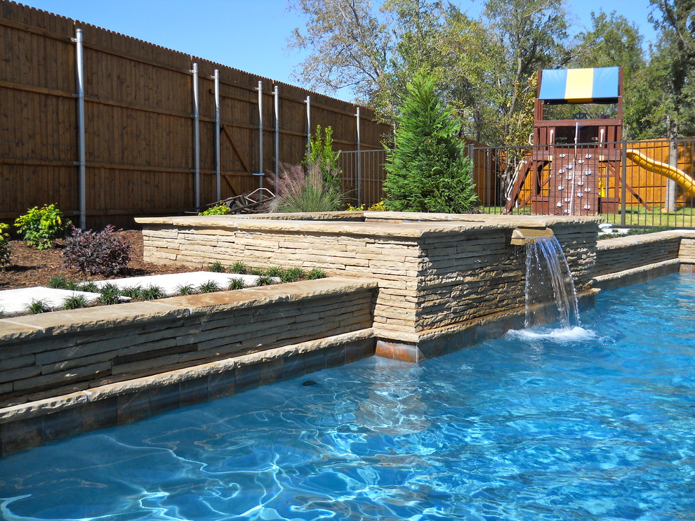 Design ideas for a mid-sized traditional backyard rectangular lap pool in Dallas with a hot tub.