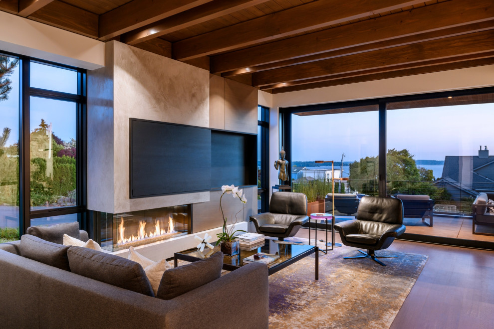 Inspiration for a mid-sized contemporary light wood floor living room remodel in Seattle with a plaster fireplace and a concealed tv