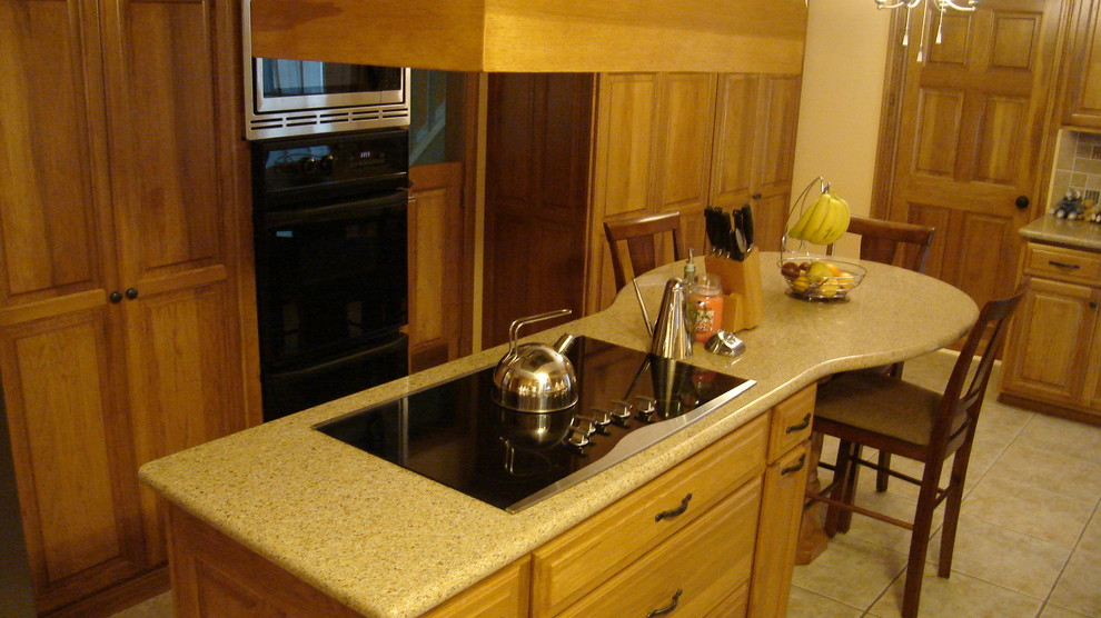 Mid-sized transitional l-shaped ceramic tile eat-in kitchen photo in Houston with a double-bowl sink, raised-panel cabinets, light wood cabinets, solid surface countertops, multicolored backsplash, subway tile backsplash, stainless steel appliances and an island