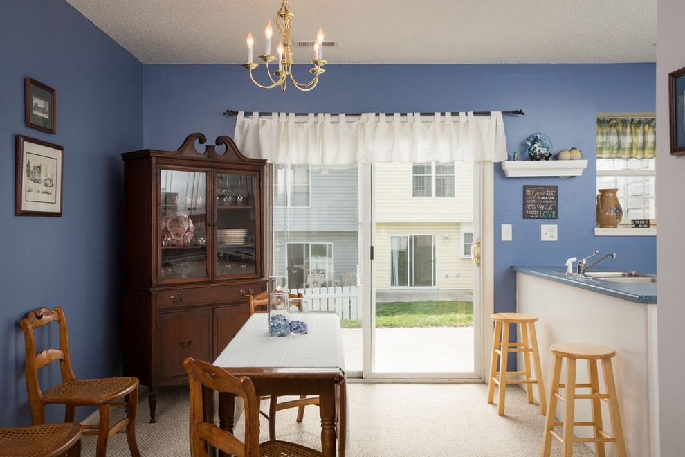 This is an example of a mid-sized transitional kitchen/dining combo in Other with blue walls and carpet.