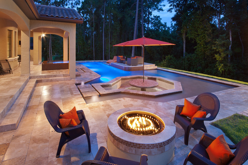 Design ideas for a mid-sized tropical backyard rectangular lap pool in Orlando with natural stone pavers and a hot tub.