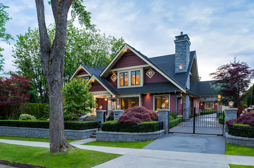 Design ideas for a large arts and crafts two-storey red exterior in Vancouver with wood siding and a gable roof.