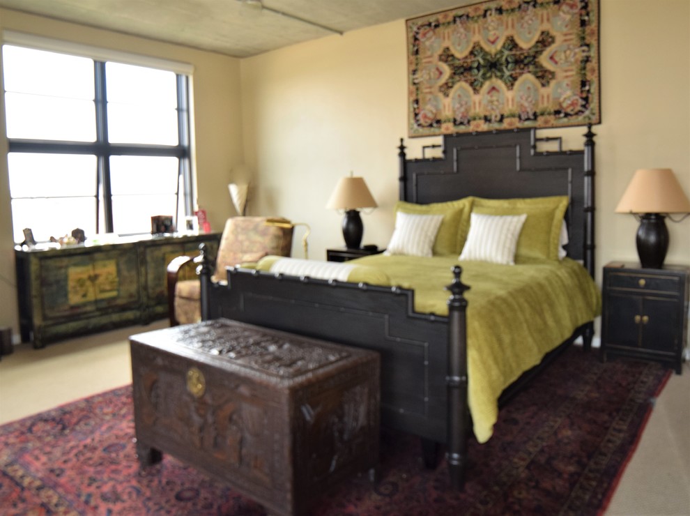 This is an example of a large asian loft-style bedroom in Denver with beige walls, carpet and beige floor.