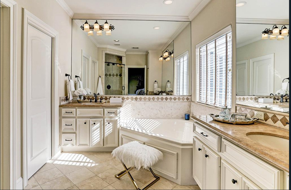 Drop-in bathtub - mid-sized transitional master porcelain tile and beige floor drop-in bathtub idea in Houston with beaded inset cabinets, white cabinets, beige walls, an undermount sink, granite countertops, a hinged shower door and brown countertops