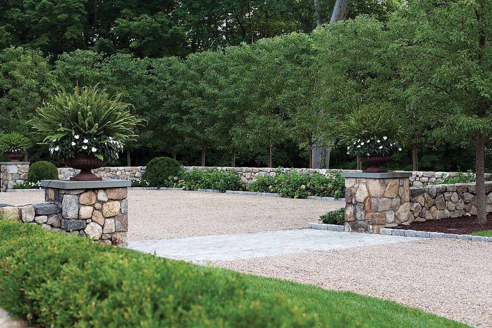 Large traditional front yard full sun driveway in New York with gravel and a garden path for spring.