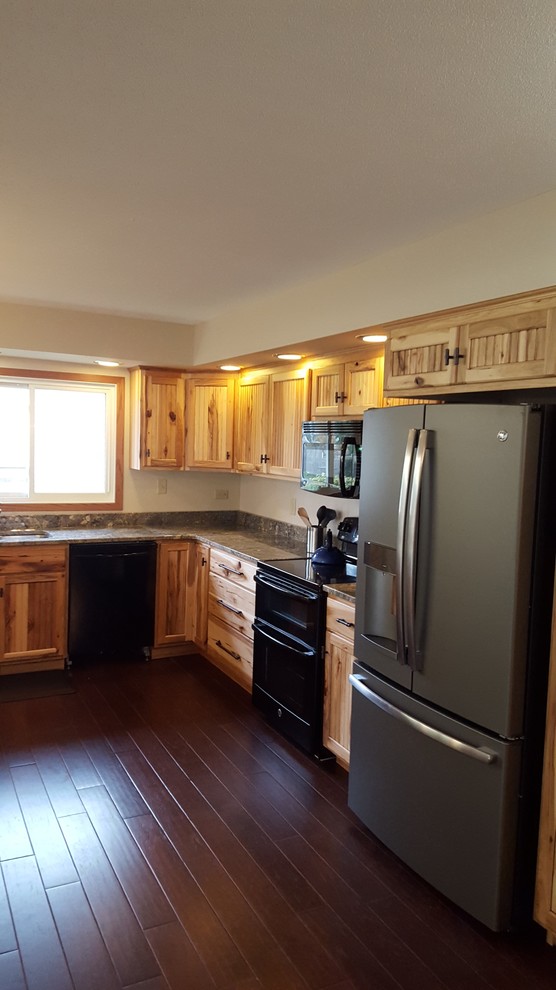 U-shaped dark wood floor eat-in kitchen photo with an undermount sink, stainless steel appliances and a peninsula