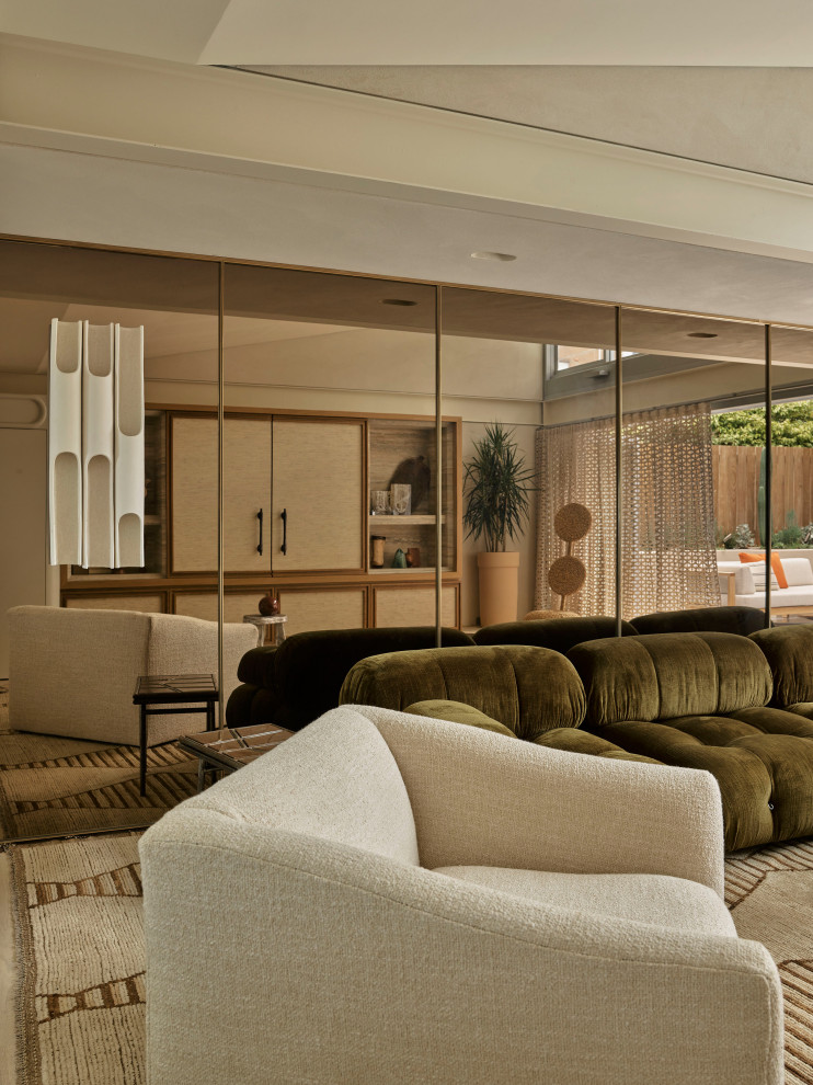 Photo of an eclectic living room in Sydney with beige walls, painted wood floors and a concealed tv.