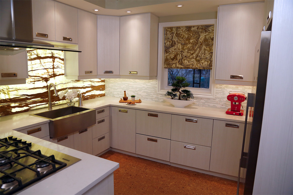 This is an example of a large contemporary u-shaped separate kitchen in Toronto with a farmhouse sink, beaded inset cabinets, white cabinets, solid surface benchtops, multi-coloured splashback, stone slab splashback, stainless steel appliances, cork floors and a peninsula.
