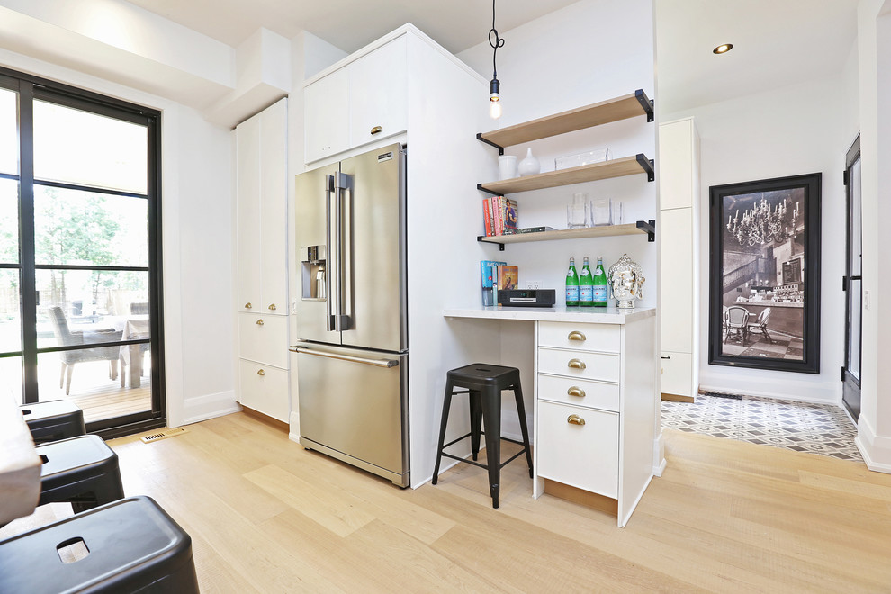 This is an example of a large scandinavian open plan kitchen in Toronto with a farmhouse sink, flat-panel cabinets, white cabinets, quartzite benchtops, multi-coloured splashback, ceramic splashback, stainless steel appliances, light hardwood floors and with island.