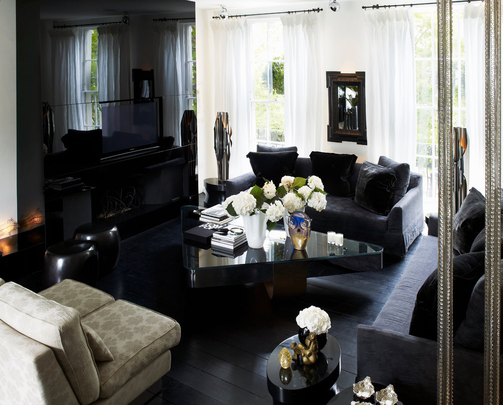 Photo of a large contemporary living room in London with a wall-mounted tv and black floor.
