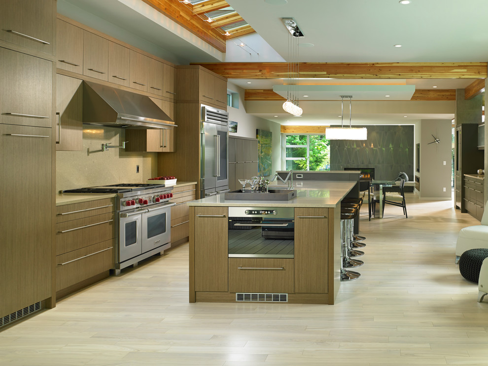 Inspiration for a large modern single-wall eat-in kitchen in Vancouver with an undermount sink, flat-panel cabinets, light wood cabinets, quartz benchtops, beige splashback, stainless steel appliances, light hardwood floors and with island.