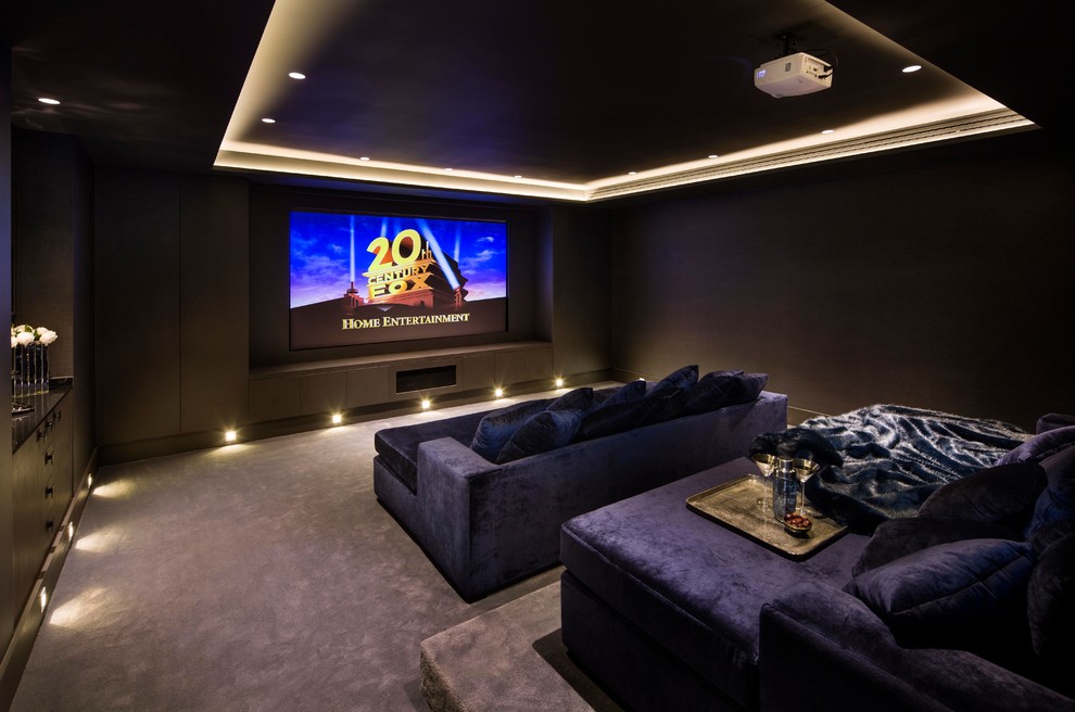 Mid-sized contemporary enclosed home theatre in London with brown walls, carpet, a projector screen and purple floor.