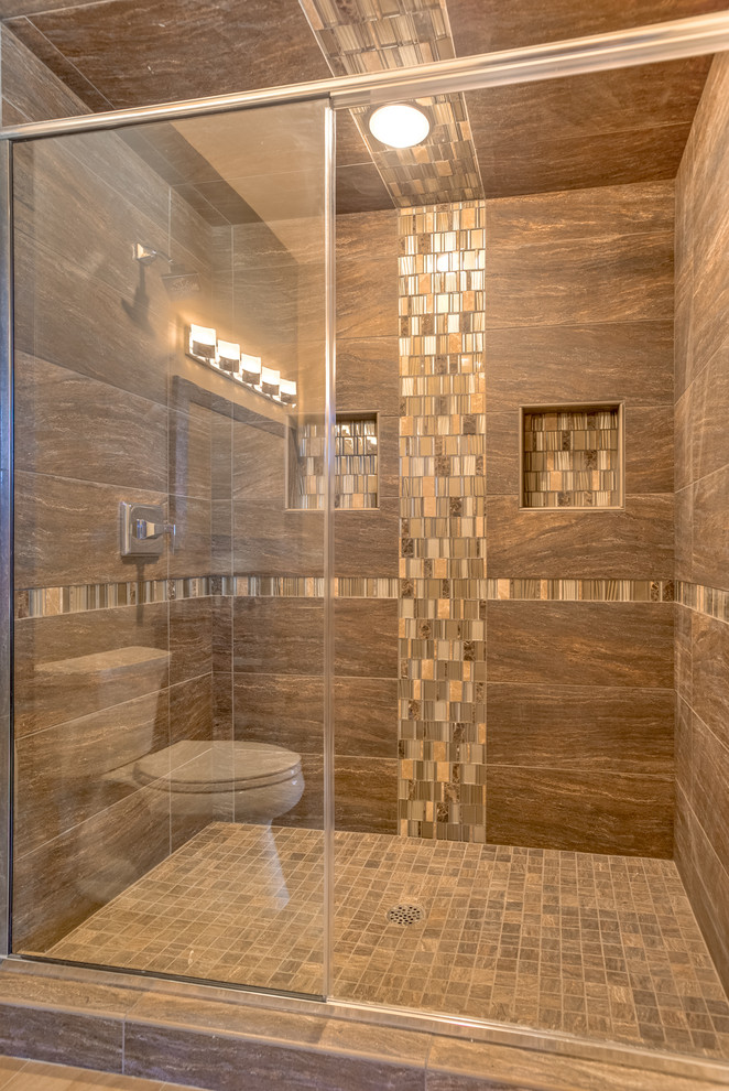 Large contemporary bathroom in Omaha with an undermount sink, recessed-panel cabinets, medium wood cabinets, engineered quartz benchtops, a drop-in tub, a one-piece toilet, brown tile, porcelain tile, beige walls, porcelain floors and with a sauna.