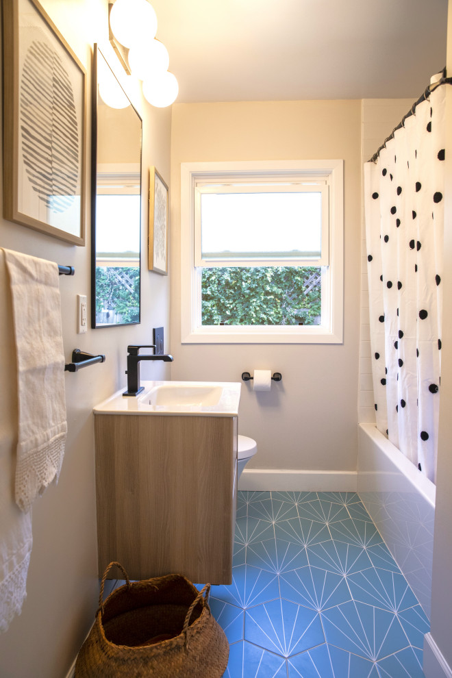 Design ideas for a medium sized family bathroom in San Francisco with flat-panel cabinets, medium wood cabinets, an alcove bath, a shower/bath combination, a wall mounted toilet, white tiles, ceramic tiles, grey walls, an integrated sink, solid surface worktops, a shower curtain, white worktops, a single sink, a floating vanity unit, porcelain flooring and green floors.
