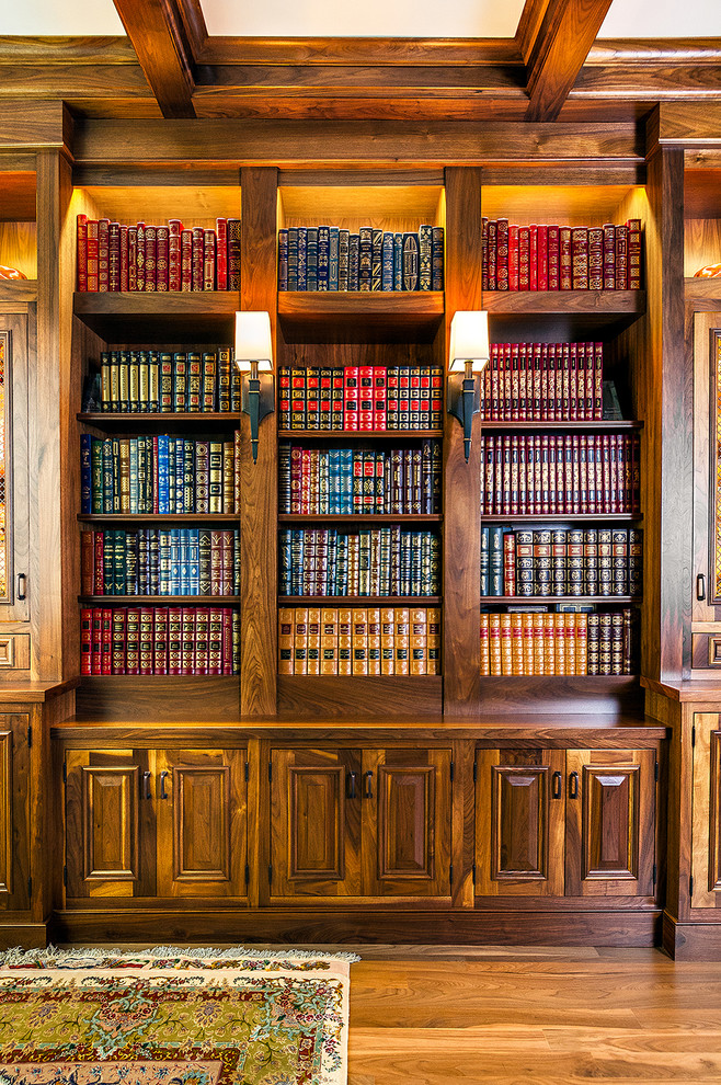 This is an example of a traditional family room in Chicago with a library and medium hardwood floors.