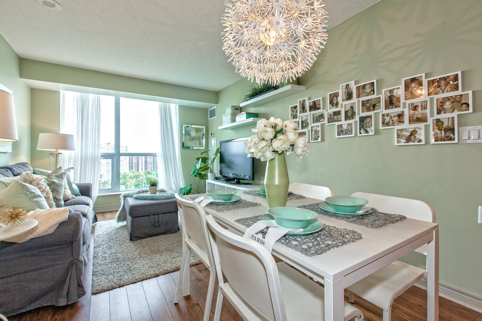 Small transitional open plan dining in Toronto with green walls, medium hardwood floors and no fireplace.
