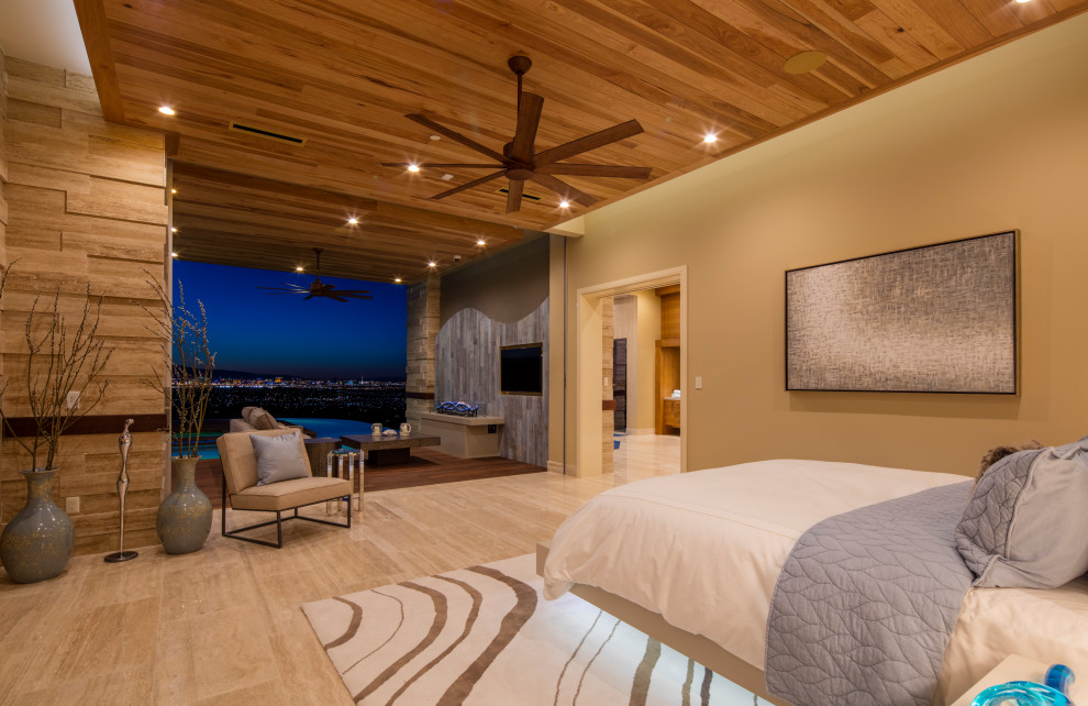 Photo of an expansive contemporary master bedroom in Las Vegas with beige walls, porcelain floors, beige floor and wood.