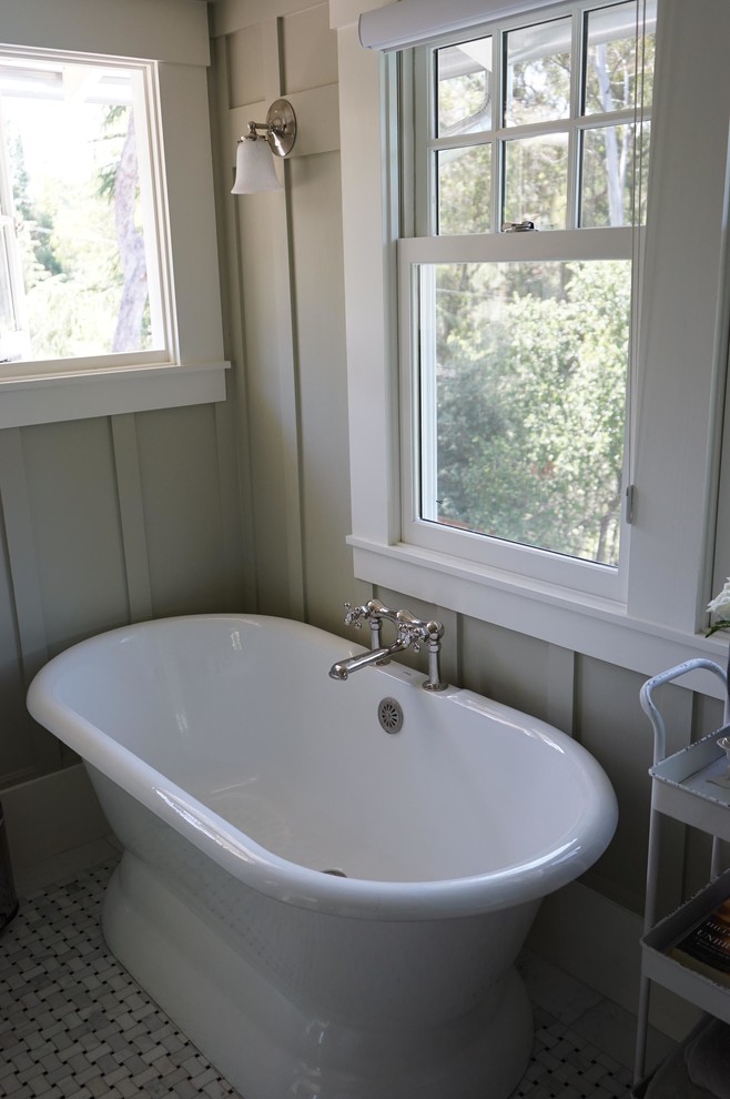 Design ideas for a mid-sized country master bathroom in San Francisco with recessed-panel cabinets, white cabinets, marble benchtops, a freestanding tub, a corner shower, white tile, stone tile, beige walls and porcelain floors.