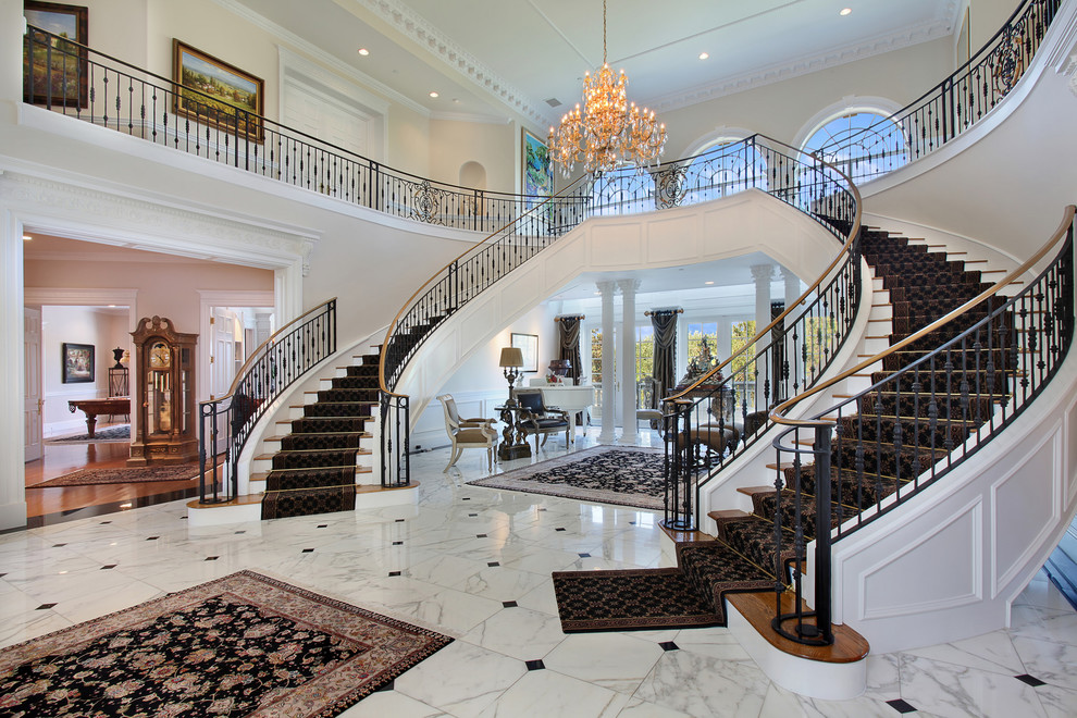 Design ideas for an expansive mediterranean carpeted u-shaped staircase in Orange County with carpet risers.